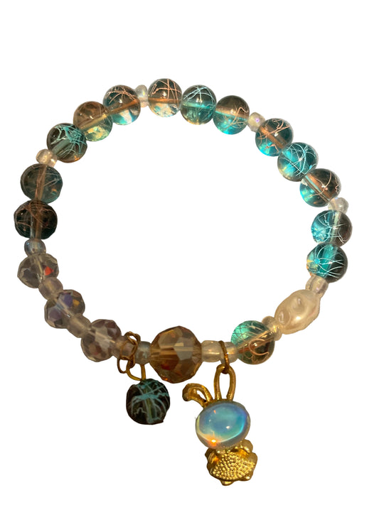 Blue and white beaded bracelet with a rabbit charm