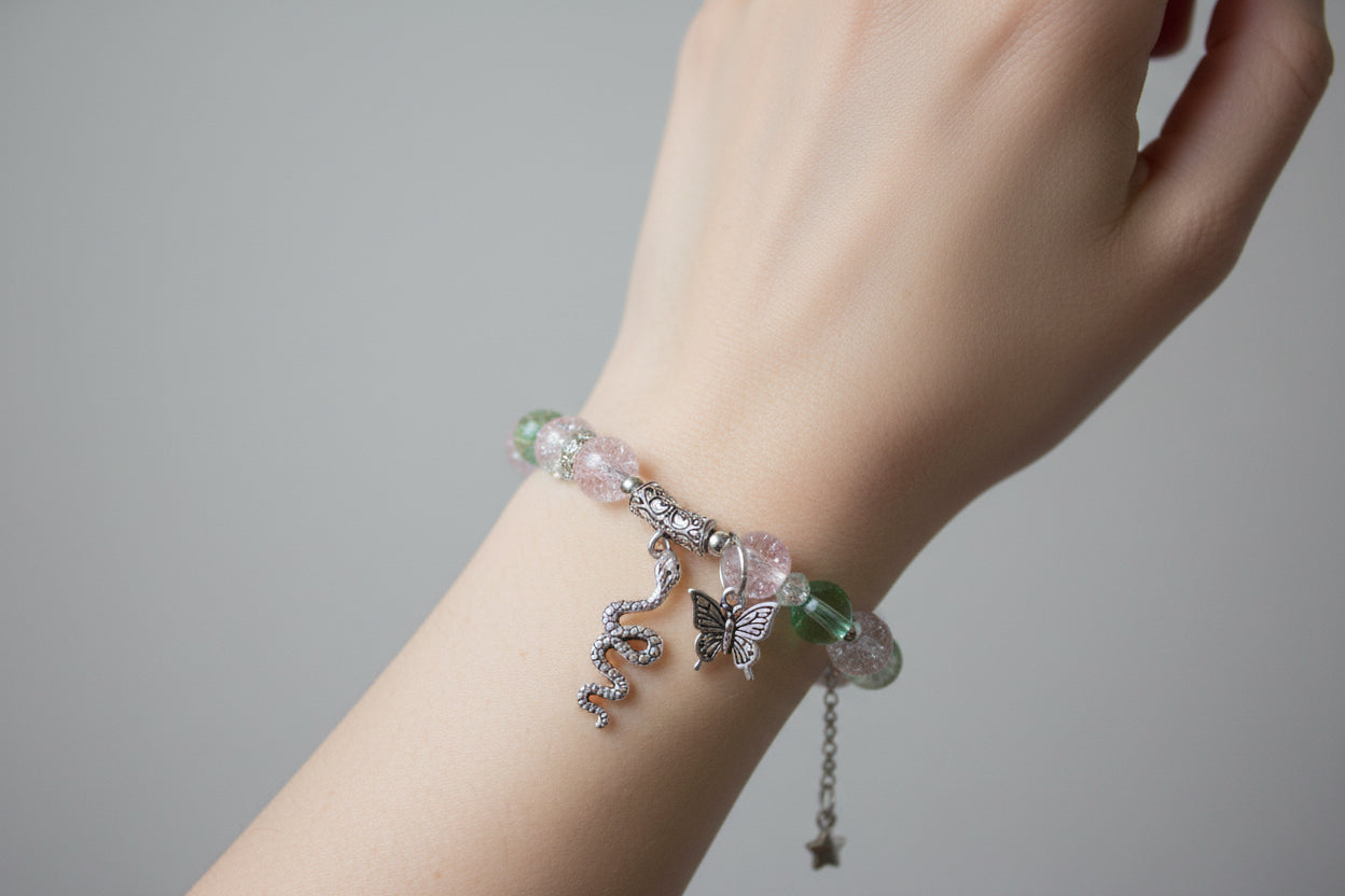 Bracelet with pink beads and silver charms