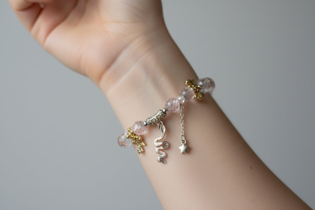 Bracelet with pink beads and silver charms