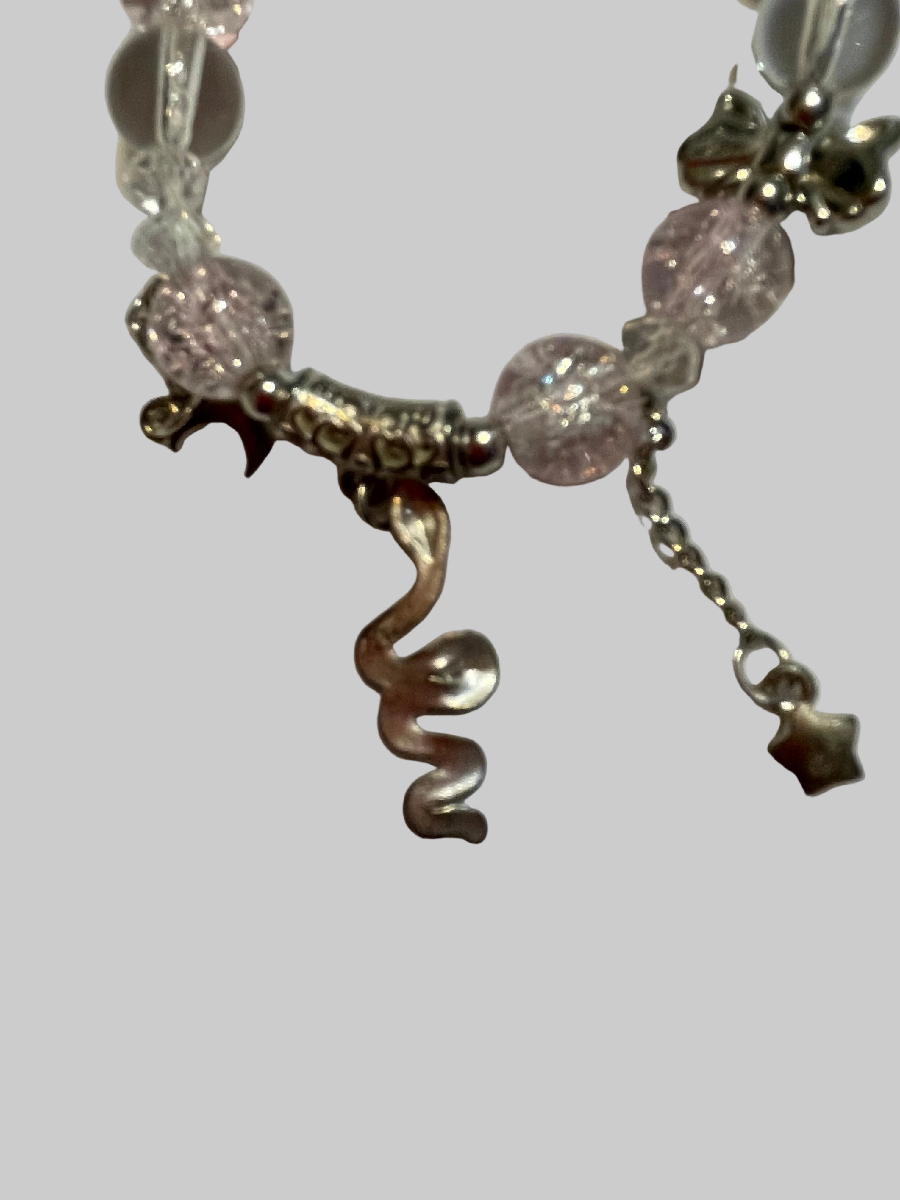 Bracelet with pink beads and silver charms