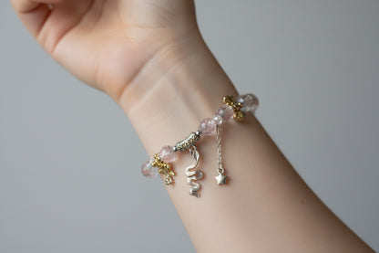 Bracelet with pink beads and silver charms