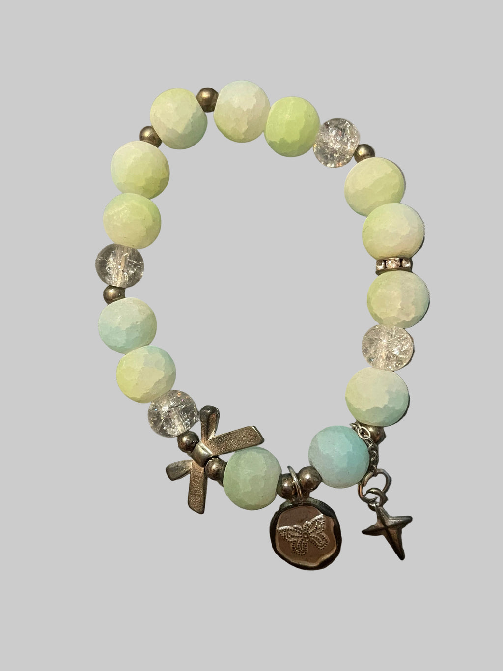A bow and a butterfly charmed green bracelet