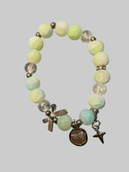 A bow and a butterfly charmed green bracelet