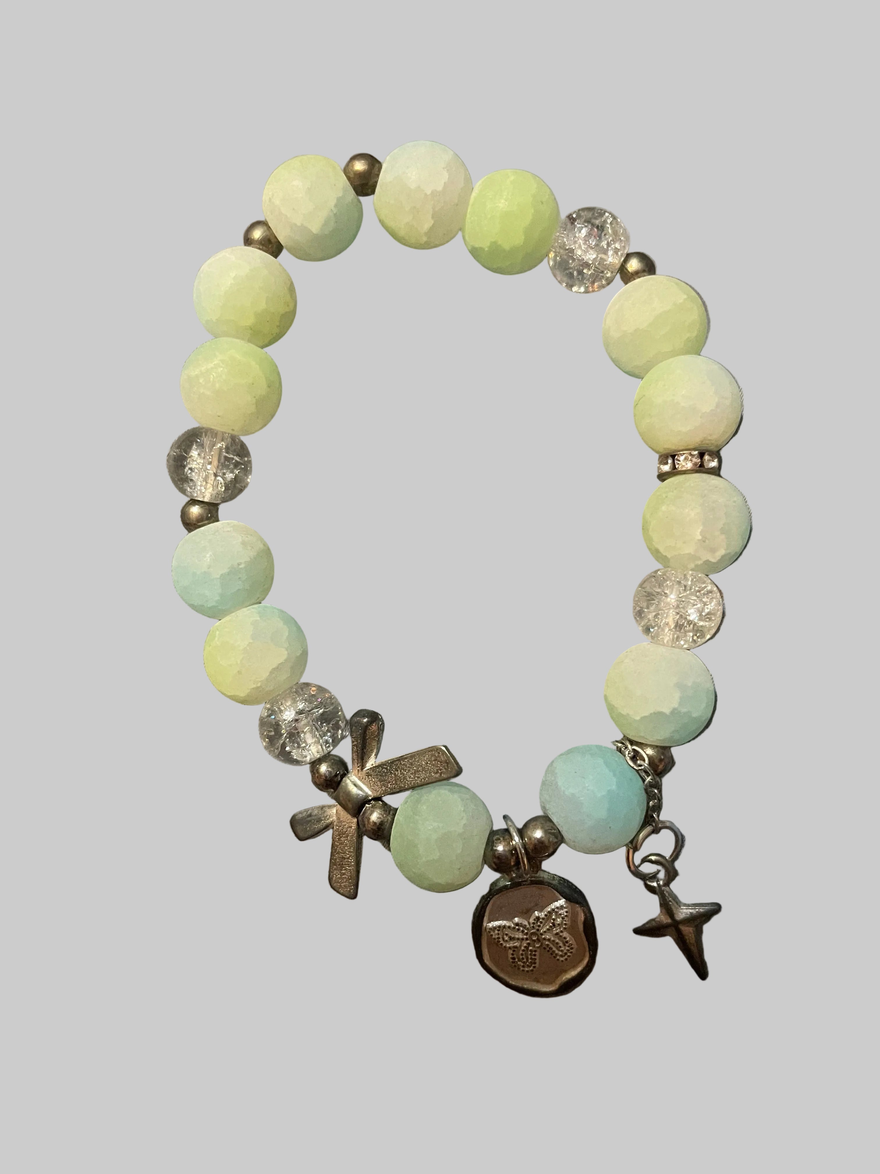 A bow and a butterfly charmed green bracelet