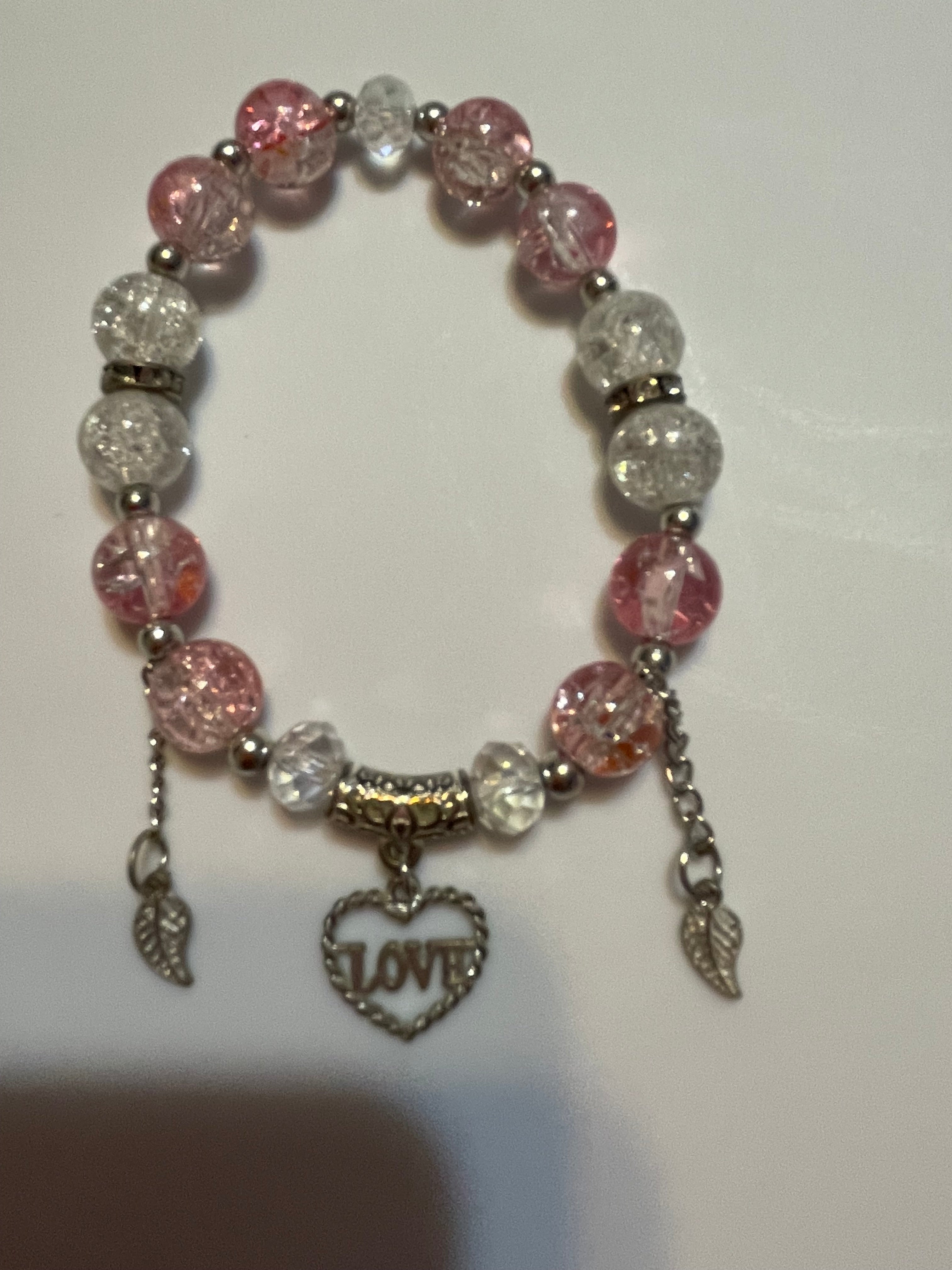 Bracelet with pink and clear beads and a 'LOVE' charm