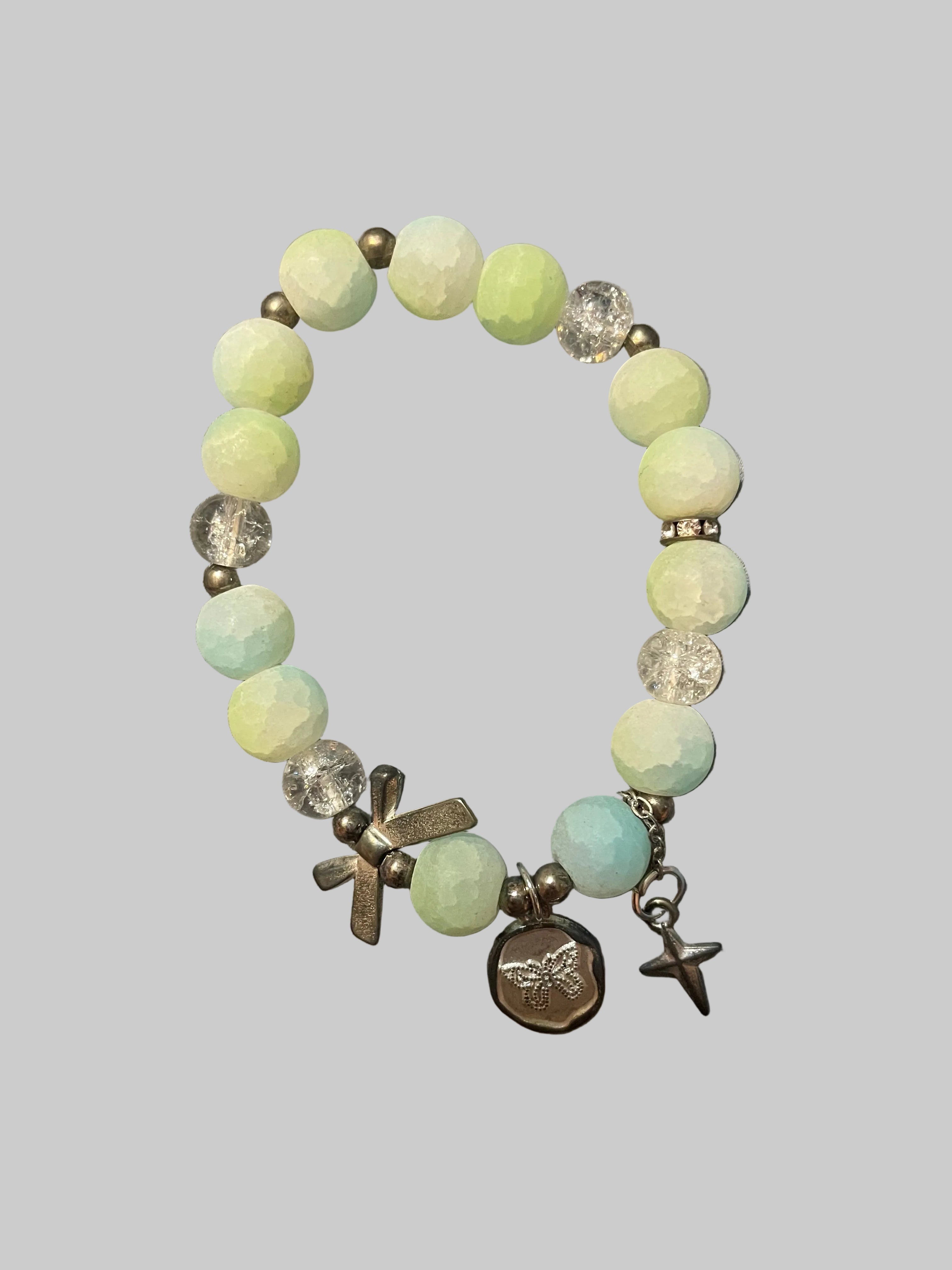 A bow and a butterfly charmed green bracelet