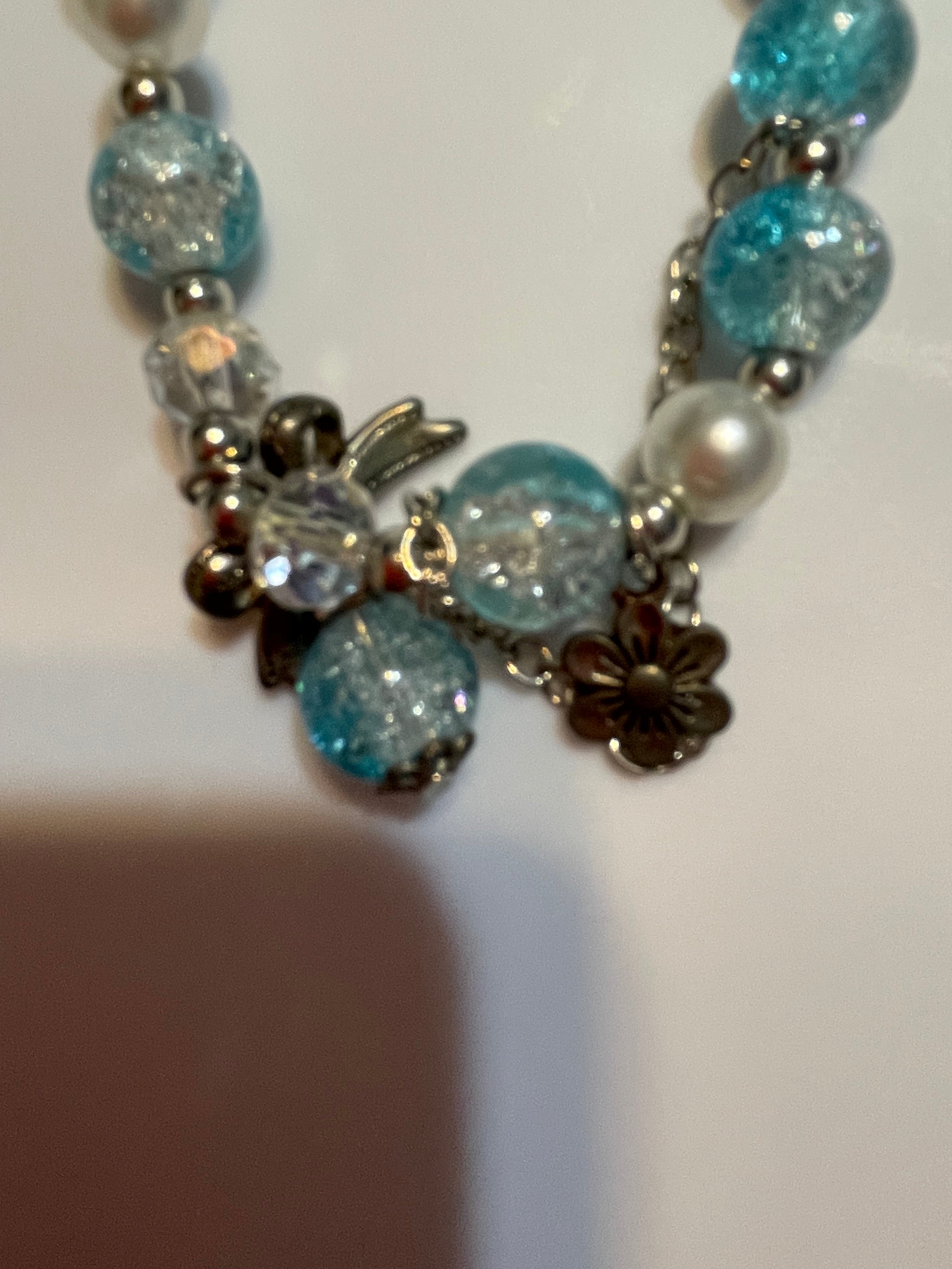 Beaded bracelet with blue, silver, and white beads.