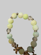 A bow and a butterfly charmed green bracelet