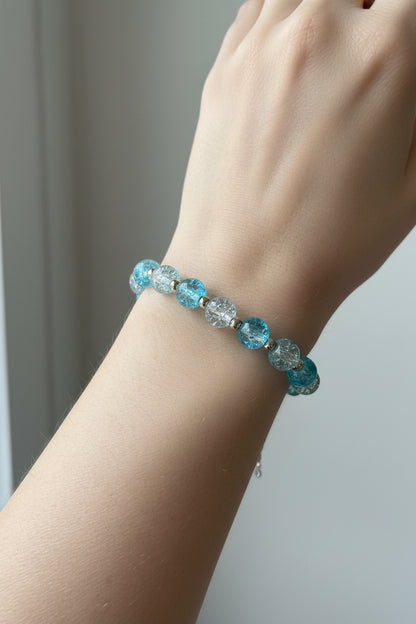 Beaded bracelet with blue, silver, and white beads.