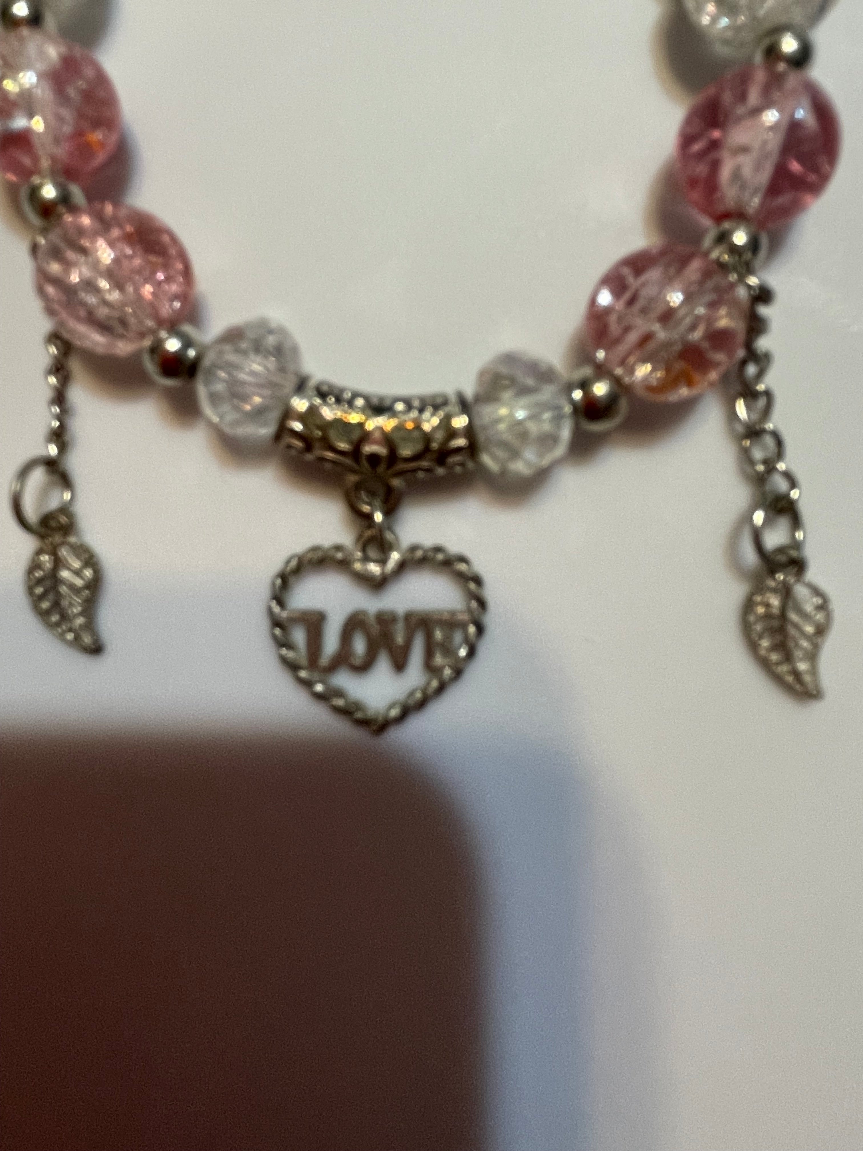 Bracelet with pink and clear beads and a 'LOVE' charm