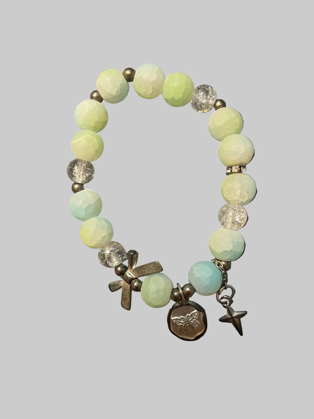 A bow and a butterfly charmed green bracelet